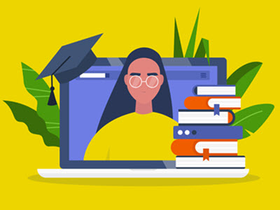 Person on laptop with books and graduation cap