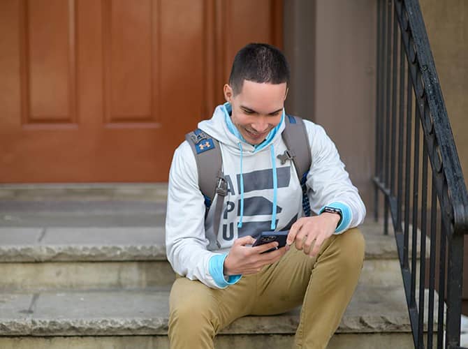 APU student looking at cellphone