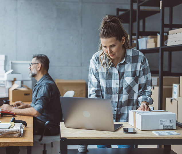 woman business owner looking at laptop