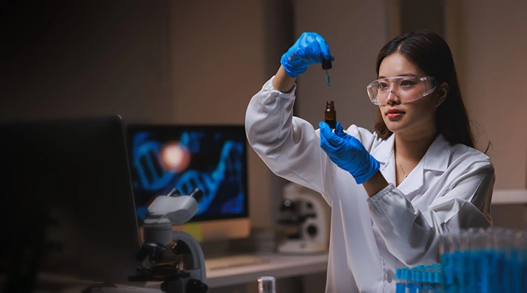 Woman holding a dripper and bottle in her hands
