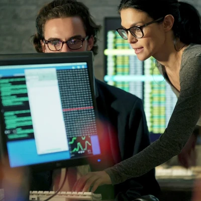 Woman and man working on computer together
