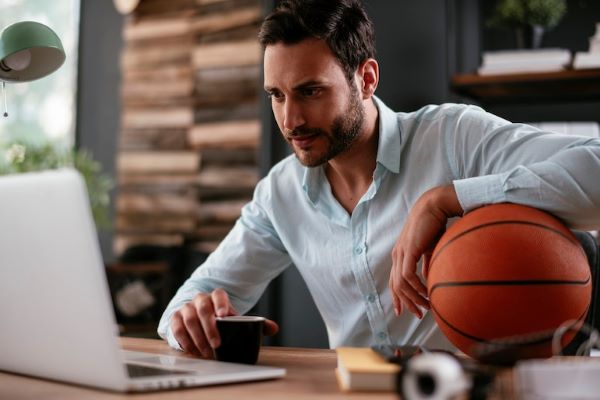 business with sports management professional holding basketball