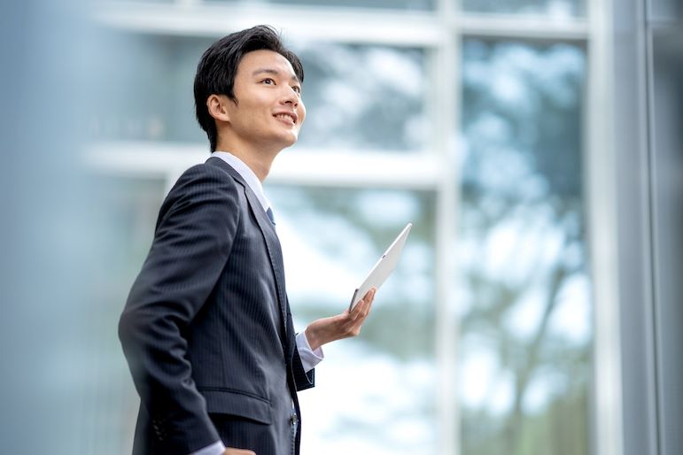 communication specialist holding tablet and smiling