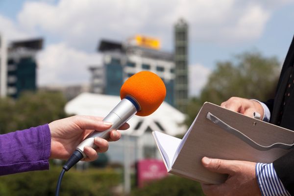 communications degree student with microphone