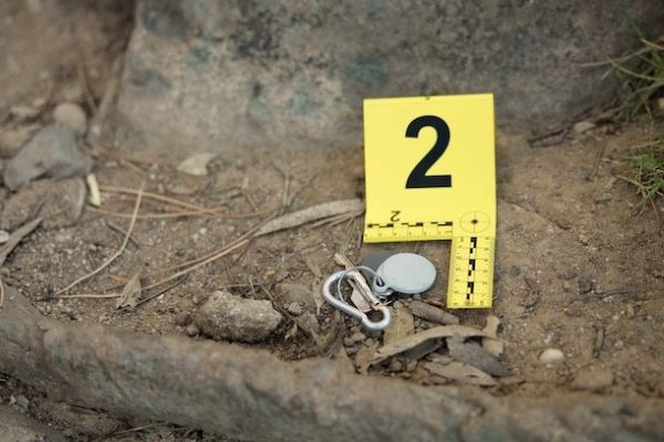 crime scene with evidence marker number 2 next to keys in dirt