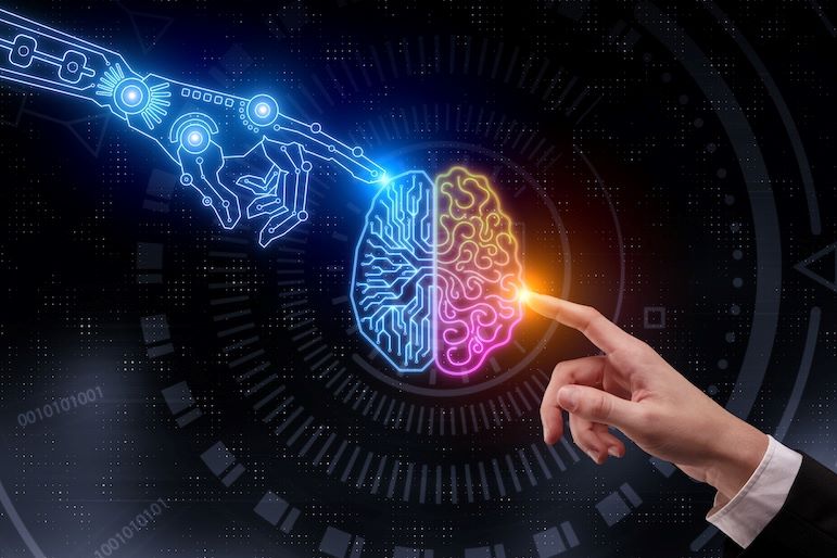 physical and digital hands touching digital image of brain