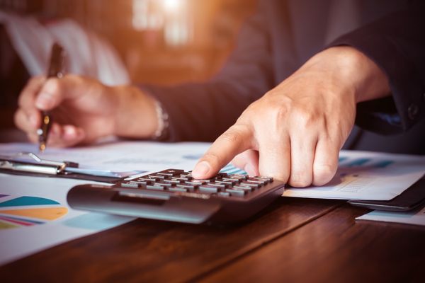 accountant working on calculator