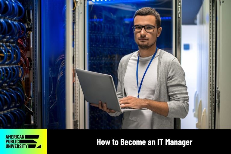 IT manager standing near servers