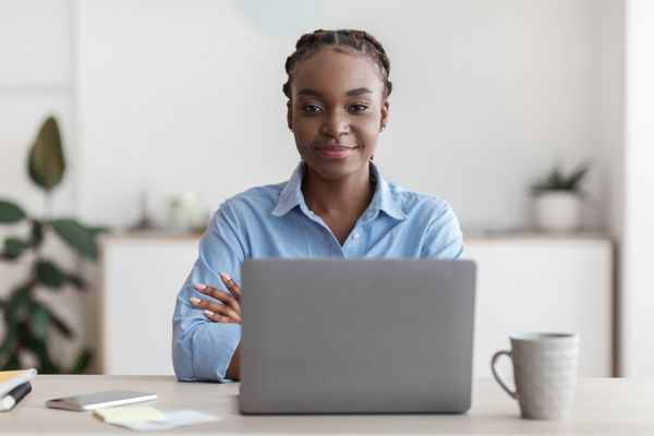 entrepreneurship student with laptop and coffee mug
