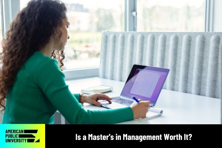 is-a-masters-inmanagement-worth-it masters in management student on laptop