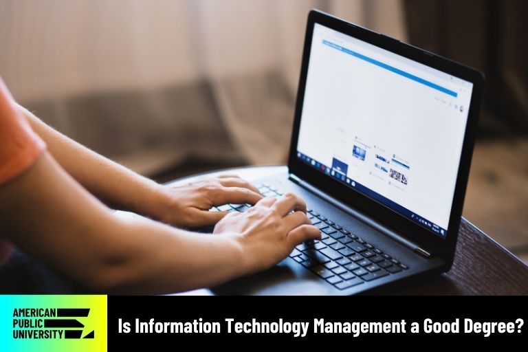 information technology management professional typing on laptop