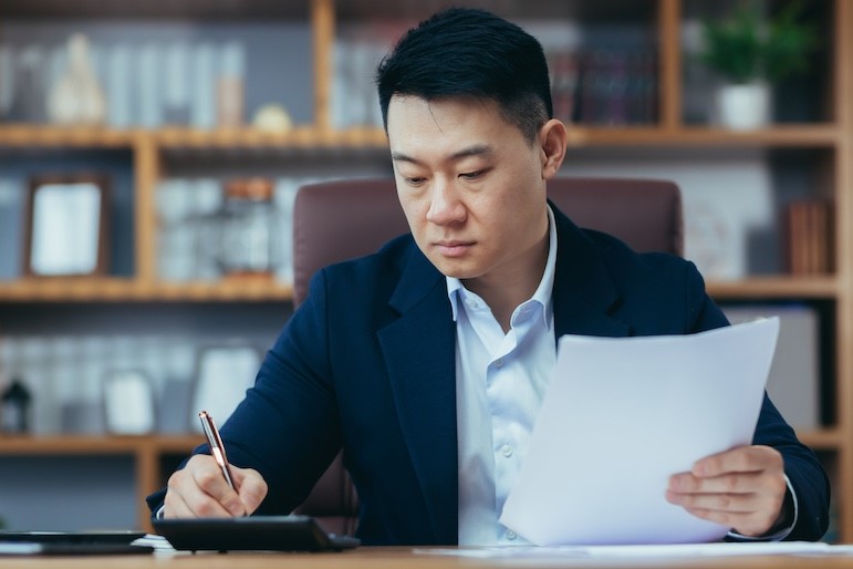 management accounting professional writing on document