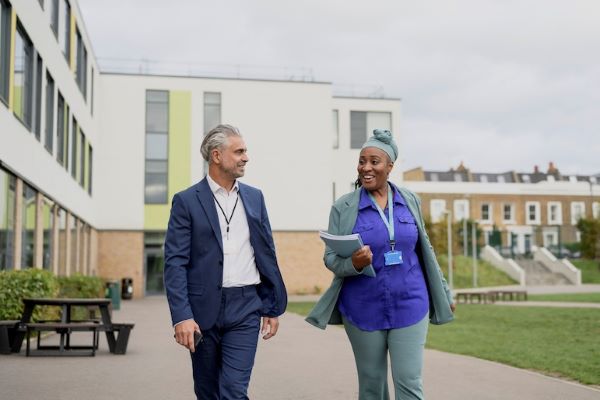 teachers walking on campus while talking