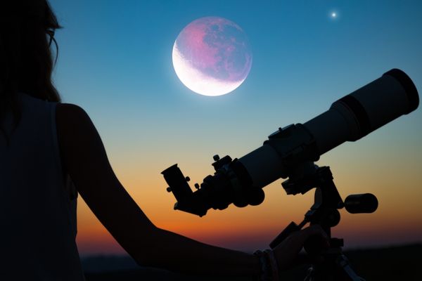 space studies degree student observing moon through telescope