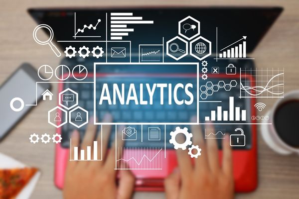 data analytics student typing on laptop