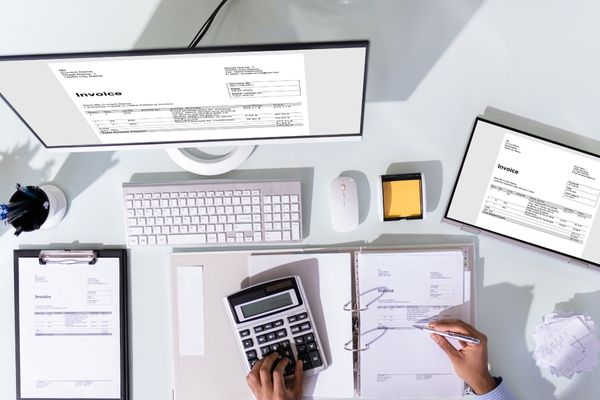 accountant working on computer and calculator