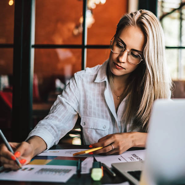 Photo of a woman looking down and writing